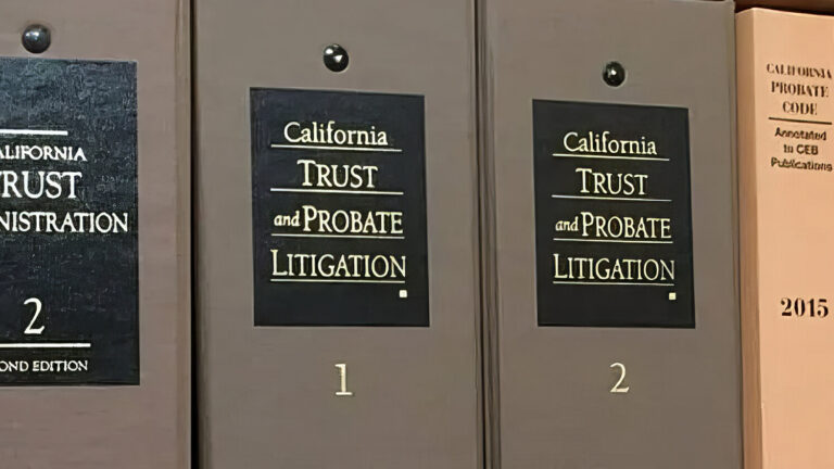 Close-up of a shelf with legal books on California trust administration, probate litigation, durable powers of attorney, estate planning, and California Probate Code. The books have brown, black, and beige covers.