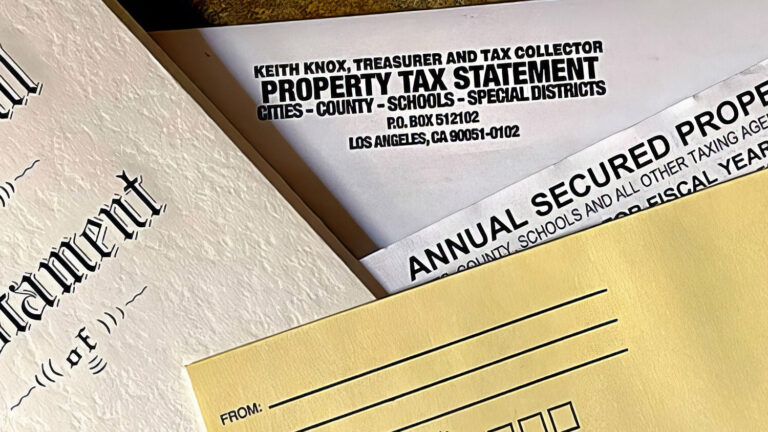Close-up of a Last Will and Testament document alongside a yellow envelope and an annual secured property tax bill from Los Angeles County.