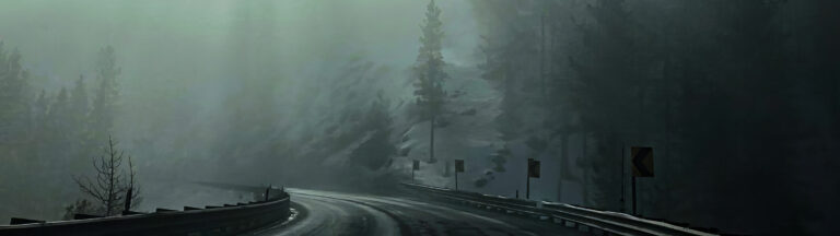 A curved, wet mountain road with guardrails and warning signs winds through a foggy, forested landscape with tall, dark trees and mist obscuring the background.