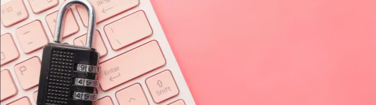 A combination padlock resting on a pink computer keyboard, symbolizing cybersecurity or data protection, with a bright pink background.