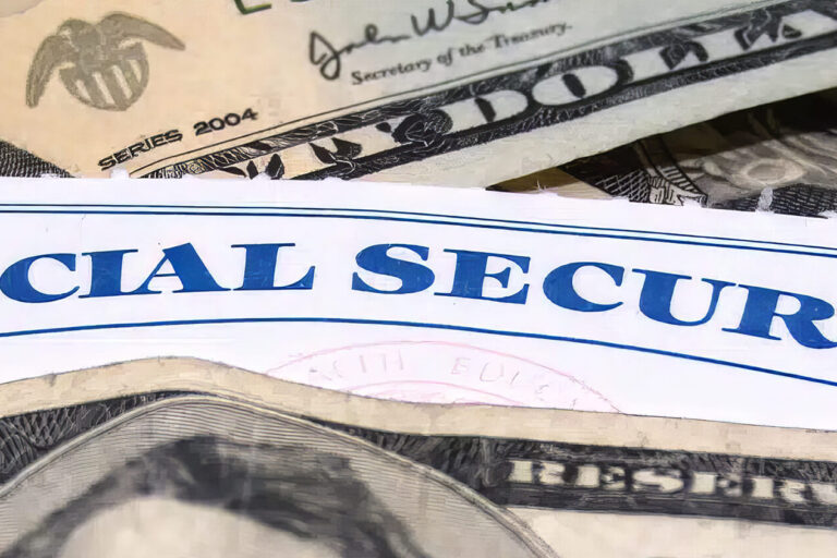A Social Security card is partially visible among overlapping U.S. dollar bills, including $20 and $100 notes, suggesting a theme of finances or social benefits.
